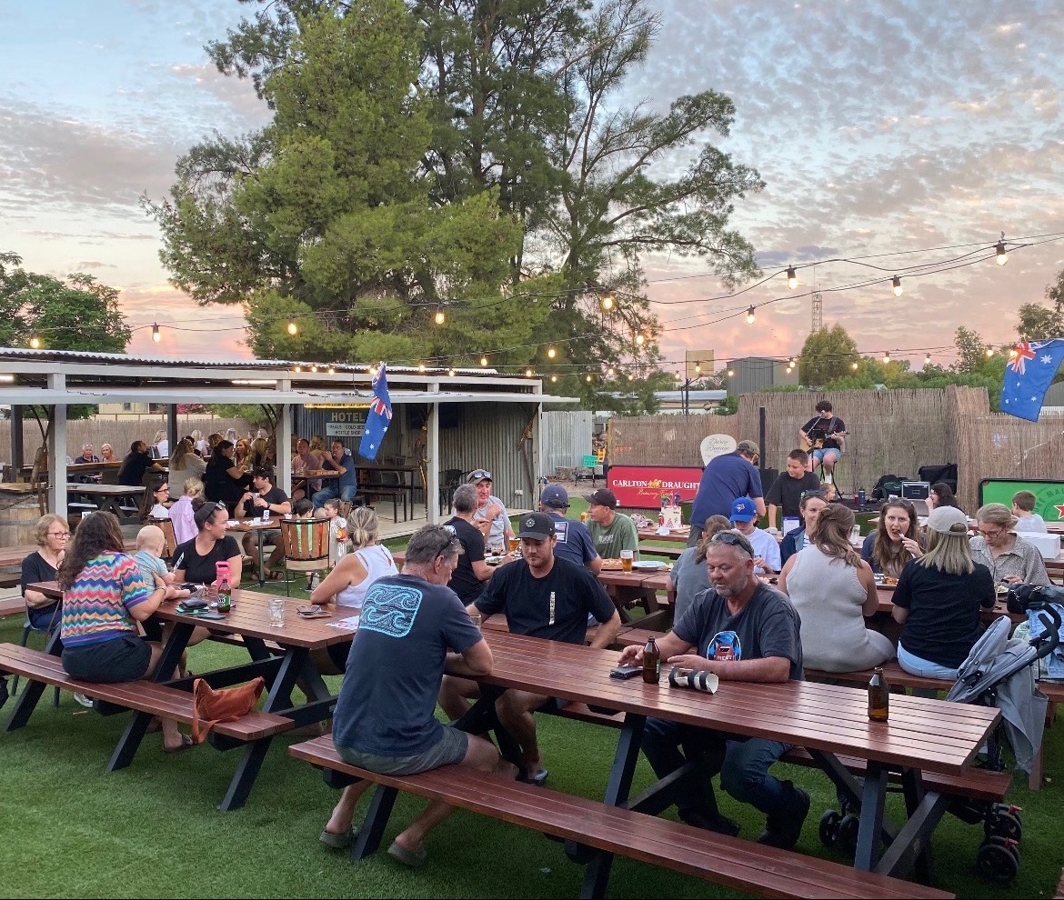 A busy beer garden full of locals at sunset