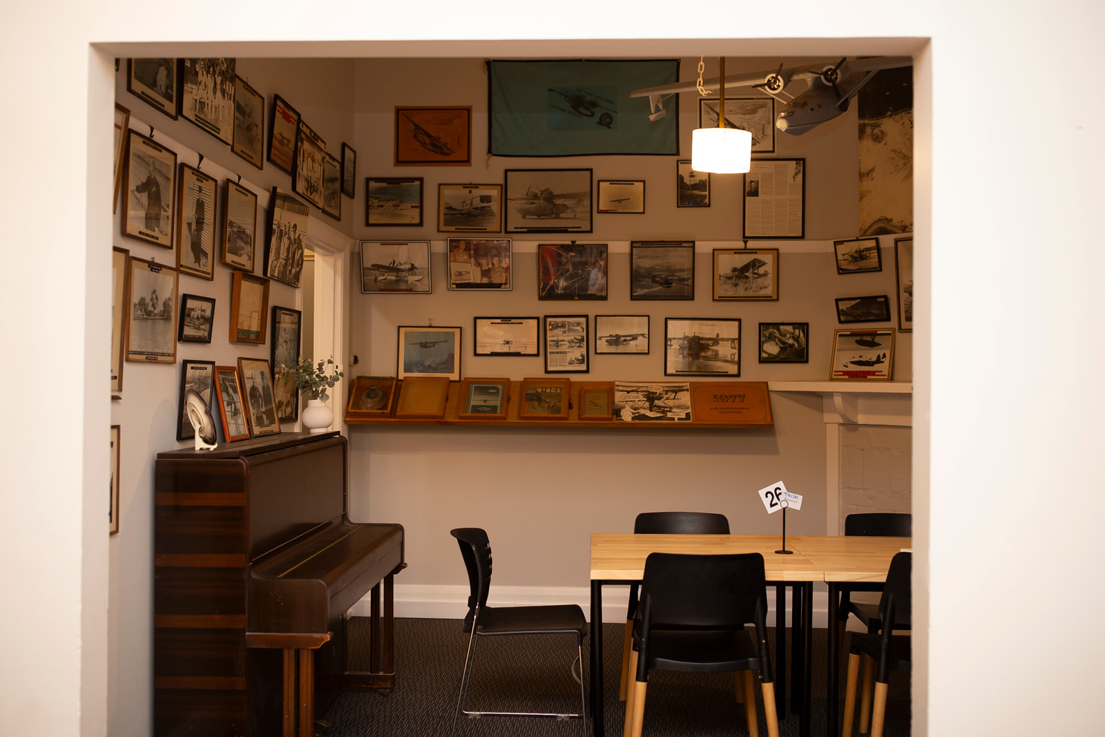 Heritage room with a piano and aviation memorabilia